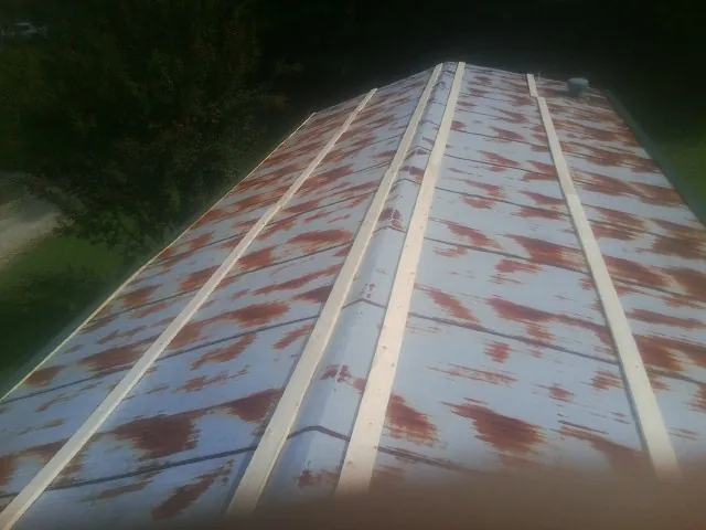 Rusted metal roof panels with new wood purlins before replacement — Storm Damage Roof Repair in Dulzura by Roofing Brothers