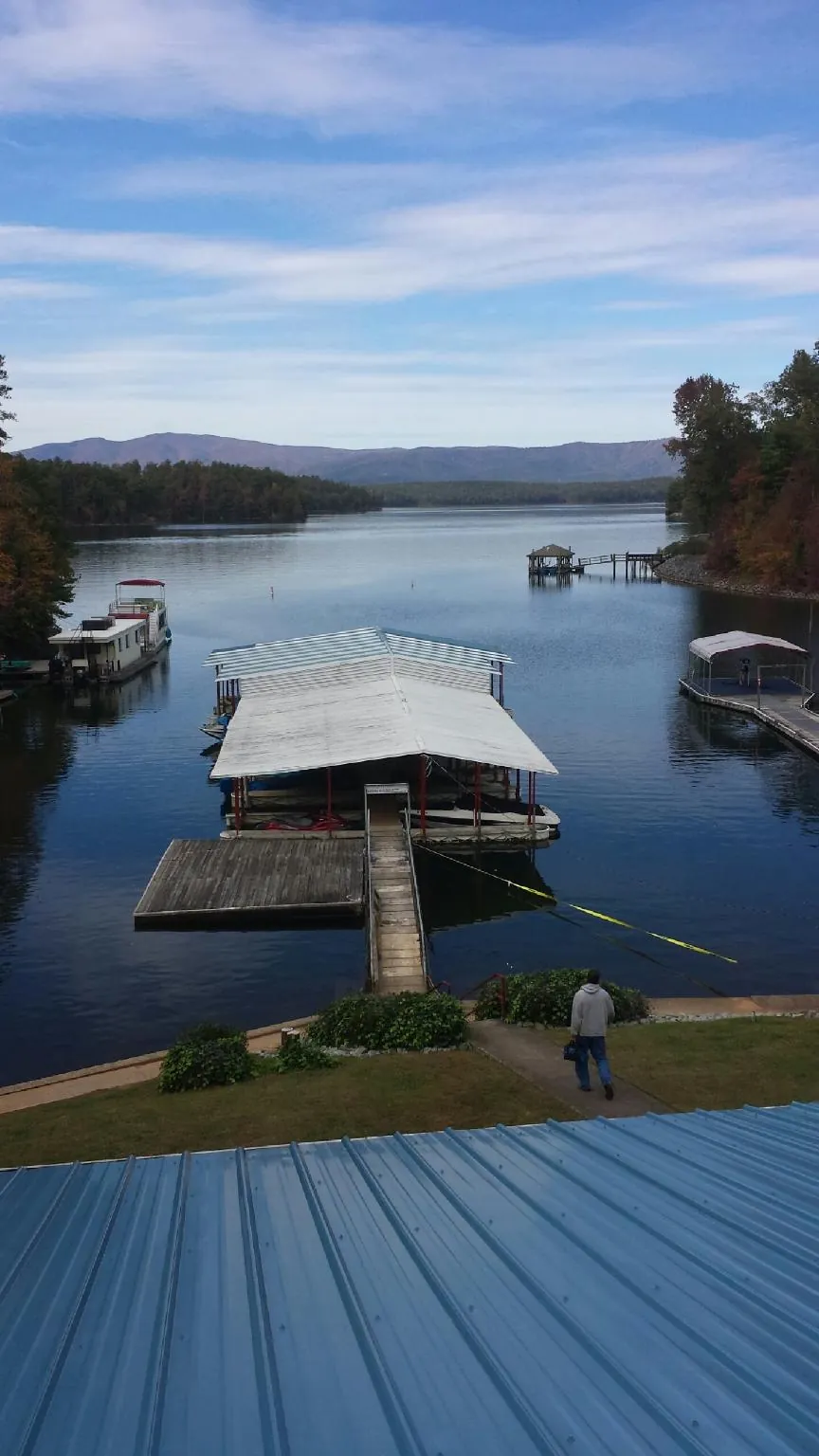 View across a lake from a newly installed blue metal roof in Dulzura